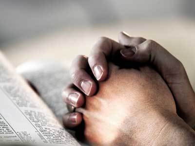  A Christian with bible praying